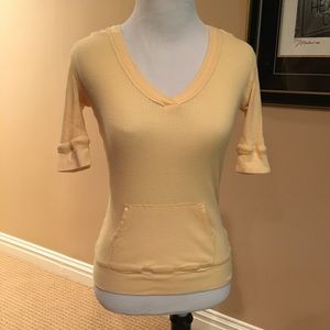 Fitted yellow v neck top w/hood and pocket.